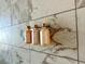 Bathroom marble tiled wall with shampoo and conditioner at 4381 W Flamingo Rd # 1504, Las Vegas, NV 89103