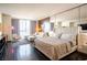 This luxury bedroom is appointed with floor to ceiling windows, dark wood floors and a comfortable sitting area at 4381 W Flamingo Rd # 1504, Las Vegas, NV 89103