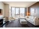 Modern living room with comfortable seating, a large window with city views, and sleek furnishings at 4381 W Flamingo Rd # 1504, Las Vegas, NV 89103
