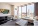 A spacious living room with city views, comfortable seating, and a unique decorative accent wall at 4381 W Flamingo Rd # 1504, Las Vegas, NV 89103