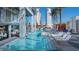 Stunning pool area with lounge chairs, resort buildings, and lush palms against the backdrop of towering Palms at 4381 W Flamingo Rd # 1504, Las Vegas, NV 89103