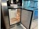 Stainless steel refrigerator with an open door, revealing shelves and compartments at 4381 W Flamingo Rd # 1504, Las Vegas, NV 89103