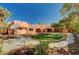 Expansive backyard with a circular lawn, mature trees, and a charming exterior, perfect for outdoor activities at 4775 N Grand Canyon Dr, Las Vegas, NV 89129