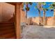 Enclosed backyard featuring palm trees and a covered patio area at 4775 N Grand Canyon Dr, Las Vegas, NV 89129