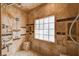 Tiled walk-in shower showcasing a shower bench and multiple shower heads at 4775 N Grand Canyon Dr, Las Vegas, NV 89129
