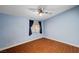 Relaxing bedroom featuring light blue walls, a ceiling fan, and a bright window with dark curtains at 4775 N Grand Canyon Dr, Las Vegas, NV 89129