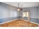 Bedroom features a ceiling fan, neutral paint, and large window at 4775 N Grand Canyon Dr, Las Vegas, NV 89129