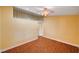 Spacious bedroom with neutral walls, tile floors, access to a loft space, and a ceiling fan at 4775 N Grand Canyon Dr, Las Vegas, NV 89129