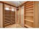 Walk-in closet with custom built-in shelving and hanging rods to keep you organized at 4775 N Grand Canyon Dr, Las Vegas, NV 89129