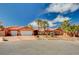 Sprawling desert home featuring a three car garage, terra cotta roof and manicured xeriscaped yard at 4775 N Grand Canyon Dr, Las Vegas, NV 89129