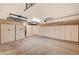 Spacious garage with ample storage cabinets and overhead racks for organization and maximizing space at 4775 N Grand Canyon Dr, Las Vegas, NV 89129