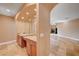 Hallway displays vanity, mirrors, granite countertops and a view of the open concept living room at 4775 N Grand Canyon Dr, Las Vegas, NV 89129