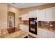 This kitchen is equipped with a double oven and sleek cooktop, making it ideal for the home chef at 4775 N Grand Canyon Dr, Las Vegas, NV 89129