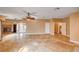 Open living room features travertine floors, ceiling fans, access to backyard, and a fireplace at 4775 N Grand Canyon Dr, Las Vegas, NV 89129