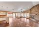 Spacious living room featuring a stone fireplace and seamless flow into the kitchen area at 4775 N Grand Canyon Dr, Las Vegas, NV 89129