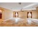 Large living room showcases travertine floors, natural light, ceiling fan and archway leading to other rooms at 4775 N Grand Canyon Dr, Las Vegas, NV 89129