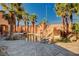 Amazing outdoor pool area with a rock slide, palm trees, and a beautifully designed pool and surrounding landscape at 4775 N Grand Canyon Dr, Las Vegas, NV 89129