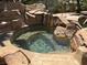 Backyard pool area featuring a rock waterfall feature and perimeter palm trees at 4775 N Grand Canyon Dr, Las Vegas, NV 89129