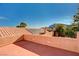 Expansive rooftop deck offering views of the tile roof, trees, and mountains at 4775 N Grand Canyon Dr, Las Vegas, NV 89129