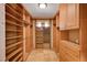 Custom walk-in closet boasts wood shelving and built in organizers for storage at 4775 N Grand Canyon Dr, Las Vegas, NV 89129
