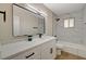 Newly renovated bathroom with quartz counters, marble tile, and modern black fixtures at 4804 Apawana Ln, Las Vegas, NV 89108