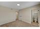 Bright bedroom with neutral walls, carpeted floor, and an ensuite bathroom for added convenience at 4804 Apawana Ln, Las Vegas, NV 89108