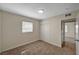 A bright bedroom with neutral walls, carpet, and sliding closet doors at 4804 Apawana Ln, Las Vegas, NV 89108