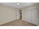 Bright bedroom with neutral walls, carpet, an ensuite bathroom and sliding closet doors at 4804 Apawana Ln, Las Vegas, NV 89108