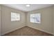 Bright bedroom with carpet, two windows and neutral walls at 4804 Apawana Ln, Las Vegas, NV 89108