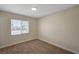 Cozy bedroom with carpeted floors, a window for natural light, and neutral decor at 4804 Apawana Ln, Las Vegas, NV 89108