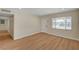 Bright living room with modern flooring, recessed lighting, and an exterior door that faces the street at 4804 Apawana Ln, Las Vegas, NV 89108