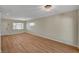 Spacious living room with wood floors, neutral walls, and a large window with natural light at 4804 Apawana Ln, Las Vegas, NV 89108
