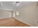 An open living space provides natural light, wood flooring, and access to the outdoors at 4804 Apawana Ln, Las Vegas, NV 89108