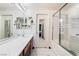 Bathroom vanity with an extended countertop and a shower with glass doors at 502 Cosmic Star Pl, Henderson, NV 89052