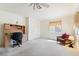 Bright bedroom featuring neutral carpet, a desk, and a cushioned chair at 502 Cosmic Star Pl, Henderson, NV 89052