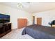 Bedroom featuring neutral carpet, a queen bed, and a mounted television at 502 Cosmic Star Pl, Henderson, NV 89052