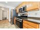 Kitchen features stainless steel appliances, stone countertops, and light wood cabinets at 502 Cosmic Star Pl, Henderson, NV 89052