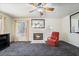 Comfortable living room with fireplace, ceiling fan, and a bright window view at 502 Cosmic Star Pl, Henderson, NV 89052