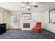 Comfortable living room with fireplace, ceiling fan, and a bright window view at 502 Cosmic Star Pl, Henderson, NV 89052