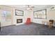 Bright living room featuring a cozy fireplace, ceiling fan, and large mirror accents at 502 Cosmic Star Pl, Henderson, NV 89052