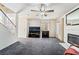 Cozy living room with fireplace, ceiling fan, and staircase leading to upper level at 502 Cosmic Star Pl, Henderson, NV 89052