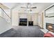 Cozy living room with fireplace, ceiling fan, and staircase leading to upper level at 502 Cosmic Star Pl, Henderson, NV 89052