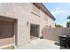Exterior patio area featuring stucco walls, sliding glass doors, and an air conditioning unit at 502 Cosmic Star Pl, Henderson, NV 89052