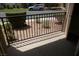 Outdoor balcony with metal railing overlooking green bushes and a parking area at 5220 Indian River Dr # 277, Las Vegas, NV 89103