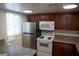 Updated kitchen features stainless steel fridge, white microwave, and dark wood cabinets at 5220 Indian River Dr # 277, Las Vegas, NV 89103