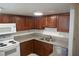Kitchen showcasing dark wood cabinetry, stainless steel appliances, and granite countertops at 5220 Indian River Dr # 277, Las Vegas, NV 89103