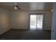 Bright living room with neutral carpeting and sliding door to balcony at 5220 Indian River Dr # 277, Las Vegas, NV 89103