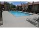 Community pool view surrounded by mature landscaping at condo complex in Nevada at 5220 Indian River Dr # 277, Las Vegas, NV 89103