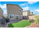 Home's backyard includes artificial grass and comfortable outdoor seating at 5252 Sunstone Mesa Dr, Las Vegas, NV 89166