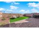 Backyard includes comfortable outdoor seating, artificial grass, and pavers at 5252 Sunstone Mesa Dr, Las Vegas, NV 89166